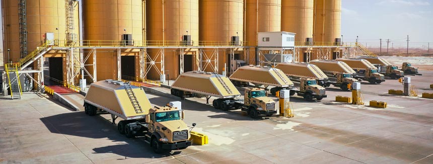 Atlas Energy Trucks going through Sand Silos